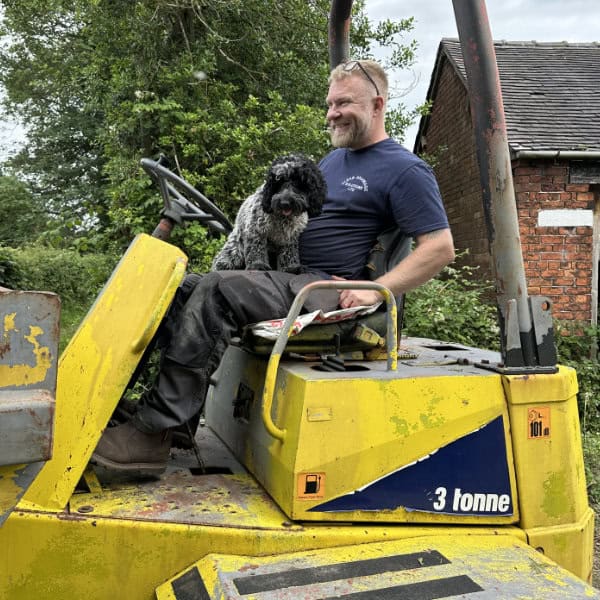 Daniel Hibberts of Clear Drainage Solutions with dog working on installing a water treatment plant