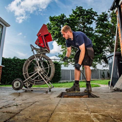 A blocked drain at a house being cleared by drain jetting it.
